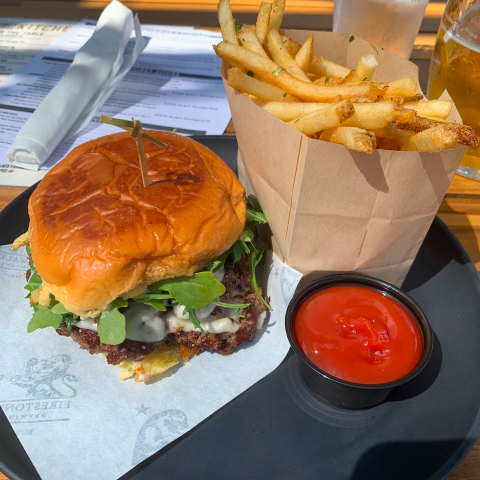 A fig-and-bacon cheeseburger with arugula and a side of fries from Firestone Walker.