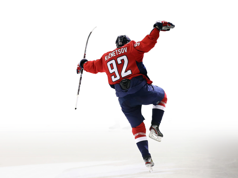 The same photo of #92, Evgeny Kuznetsov, celebrating a goal, but the background has been meticulously removed.