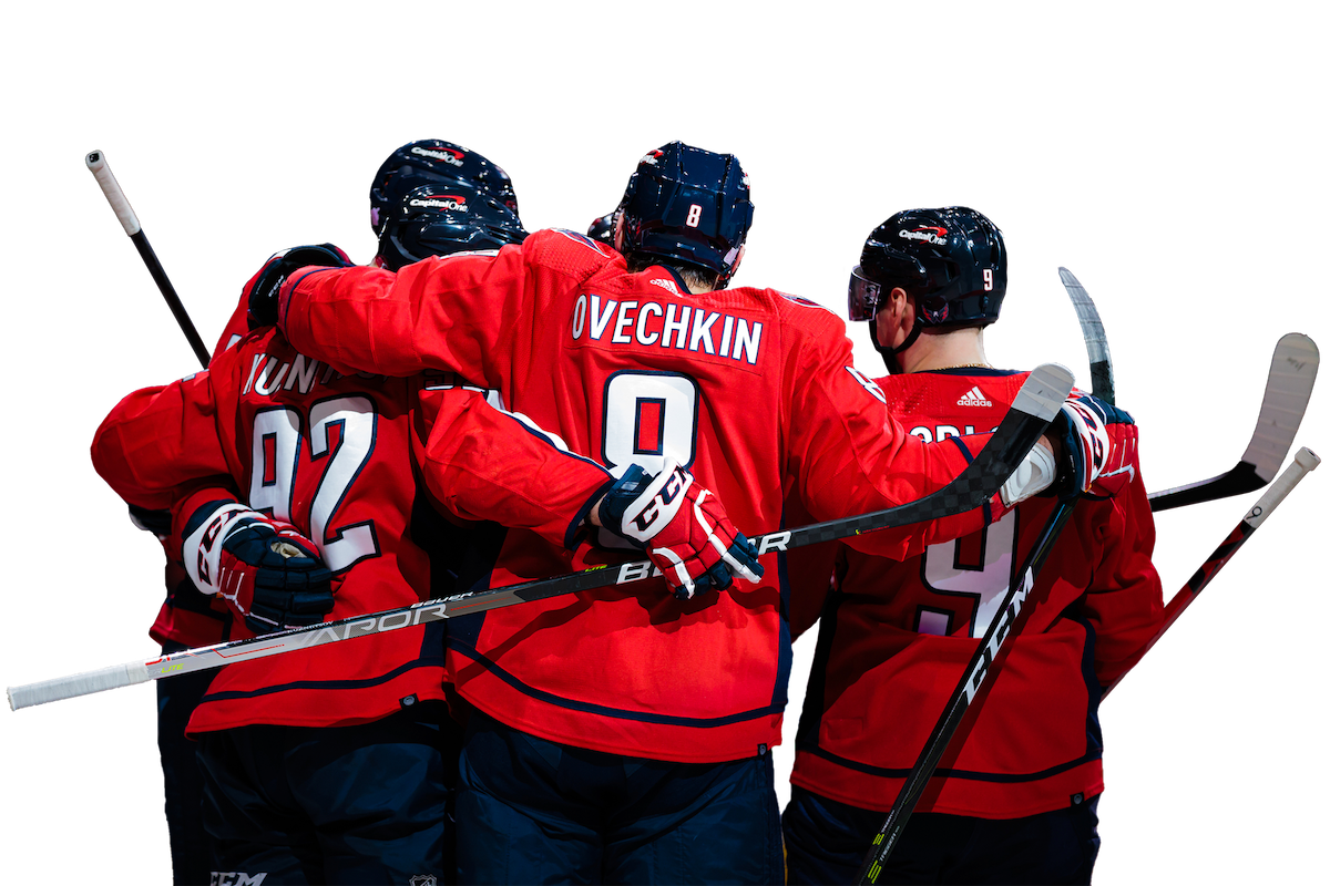 The same photo of the huddled hockey players celebrating, but the background has been meticulously removed.