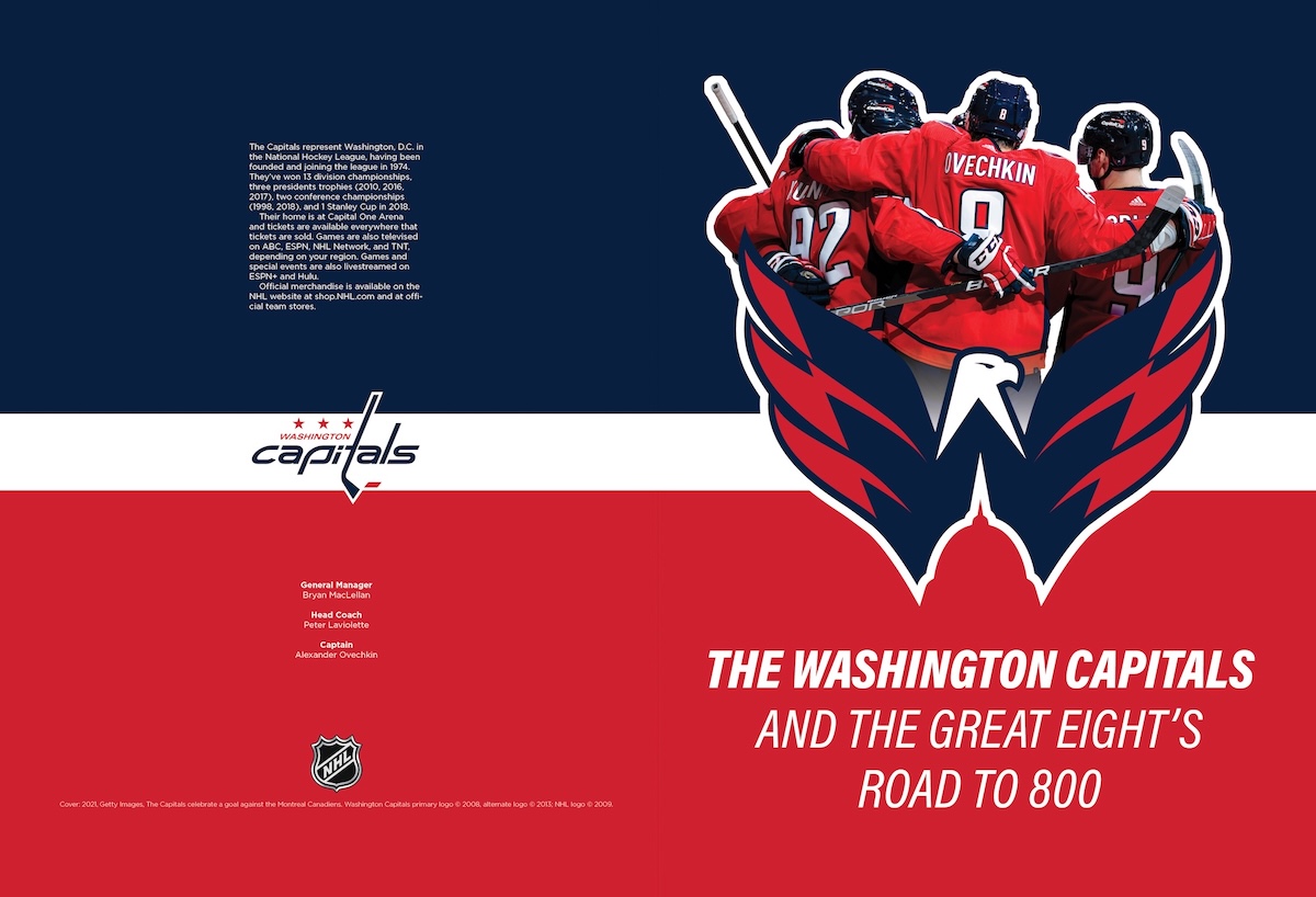 The same cover spread but the top half is using a navy blue instead of the bright red, because the team members are wearing red uniforms, and there are some layout changes to the text on the back (left) side.